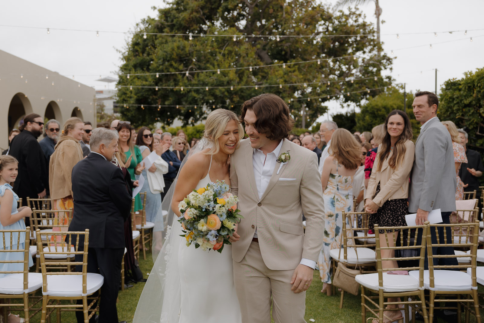 Bride and groom walk back down the aisle after their ceremony